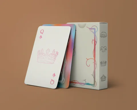 A stood box of cards with two cards stood against it